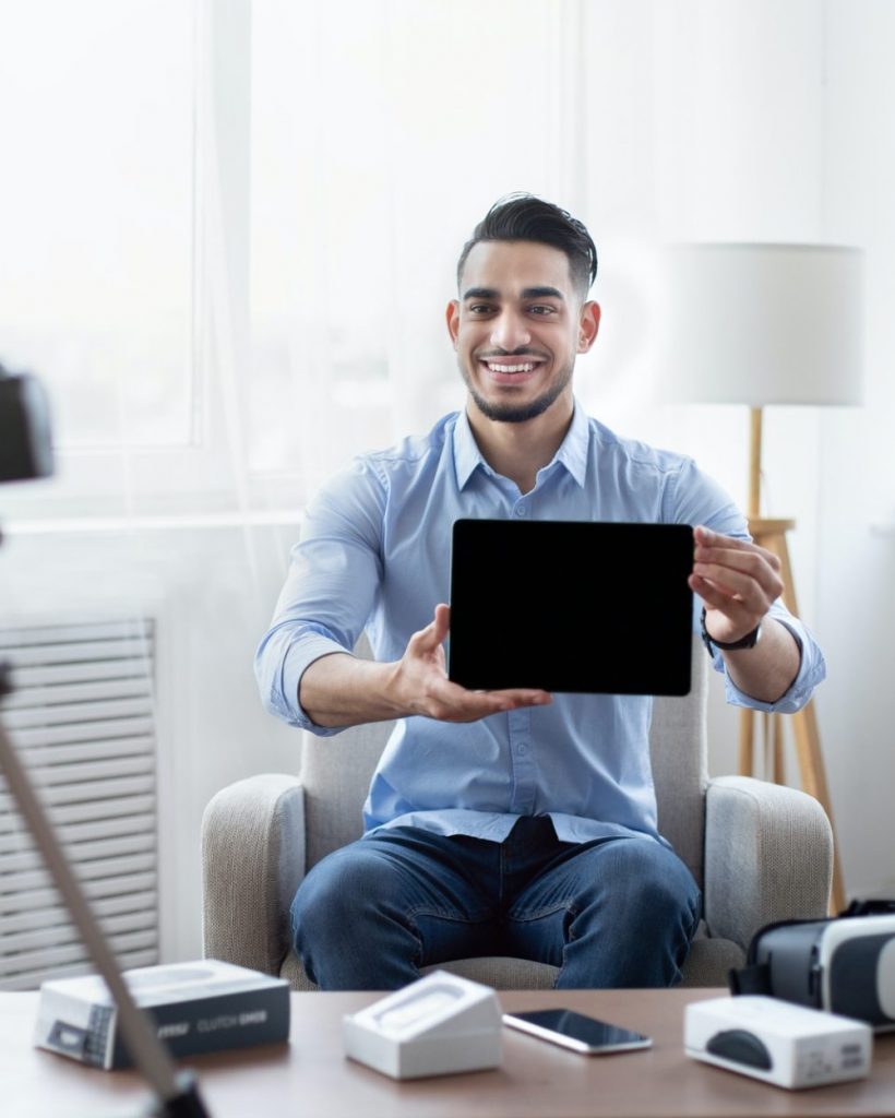 arab-male-influencer-shooting-video-review-of-modern-tablet-computer-on-professional-dslr-camera-at-e1651201628317-po25i2p69wo2e8m0yssnot3ltlwuv8c2dyc95lbsao