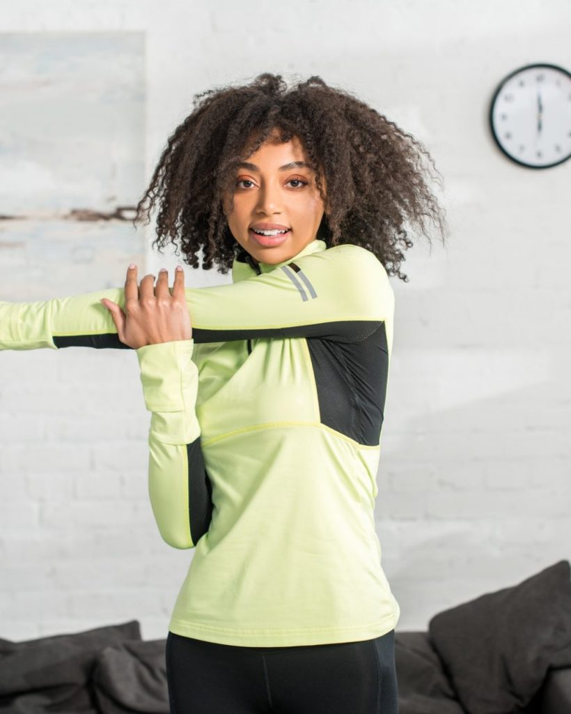 sportive-african-american-girl-warming-up-at-home-e1651201831434-po25nckkmfvzjgy862vaoh6ptfx0239ug24c3hi9ds